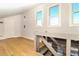 Bright hallway with wood floors featuring a staircase and windows for natural light at 707 Palmetto Blvd, Edisto Island, SC 29438