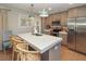 Modern kitchen featuring stainless steel appliances, stone countertops, and a breakfast bar at 707 Palmetto Blvd, Edisto Island, SC 29438