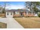 Inviting brick home with a long driveway and a well-manicured lawn, providing a welcoming curb appeal at 709 Wantoot Blvd, Charleston, SC 29407