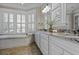 A luxurious bathroom featuring a soaking tub, granite countertops, and decorative plants at 720 Island Park Dr # 104, Charleston, SC 29492