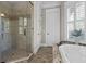 An elegant bathroom featuring a walk-in shower, soaking tub, and granite countertops at 720 Island Park Dr # 104, Charleston, SC 29492