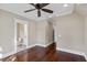 A neutral bedroom with hardwood floors, a ceiling fan, and an ensuite bathroom featuring a toilet and vanity sink at 720 Island Park Dr # 104, Charleston, SC 29492
