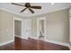 A bright bedroom with hardwood floors and a view of the ensuite bathroom through an open doorway at 720 Island Park Dr # 104, Charleston, SC 29492