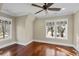 Bright bedroom with hardwood floors, neutral walls, and lots of natural light from two large windows at 720 Island Park Dr # 104, Charleston, SC 29492