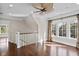 A naturally lit bonus room with hardwood floors, lots of windows, and stairs leading to a lower level at 720 Island Park Dr # 104, Charleston, SC 29492