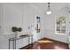 Bright foyer with elegant woodwork, decorative console table and a view to the outside at 720 Island Park Dr # 104, Charleston, SC 29492