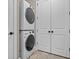 A laundry room featuring a stacked washer and dryer unit and access to a utility closet at 720 Island Park Dr # 104, Charleston, SC 29492