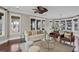 Bright, open living space featuring large windows, comfortable seating, and a stylish ceiling fan at 720 Island Park Dr # 104, Charleston, SC 29492
