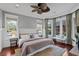 A well-lit main bedroom with a ceiling fan, hardwood floors, and bay windows at 720 Island Park Dr # 104, Charleston, SC 29492