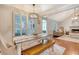 Stylish dining room open to the living area features natural light and a rustic table at 764 Brown Dr, Charleston, SC 29412