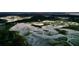 Breathtaking aerial view of a marshland property with a unique home surrounded by lush greenery at 7753 Blue House Ln, Edisto Island, SC 29438