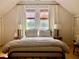 This bedroom features two windows and two lamps to match the bedspread, side tables, and light fixtures at 7753 Blue House Ln, Edisto Island, SC 29438