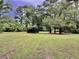 A beautiful lot with large shade trees and a road leading to a picturesque location at 7753 Blue House Ln, Edisto Island, SC 29438