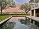 Beautiful pool featuring a tranquil view of lush greenery and a picturesque sunset sky at 7753 Blue House Ln, Edisto Island, SC 29438