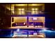 Enjoy the evening ambiance by the pool with an outdoor bar, TV, and comfortable seating area at 7753 Blue House Ln, Edisto Island, SC 29438