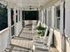Charming porch with rocking chairs, a swing, and American flag, creating a cozy outdoor space at 7753 Blue House Ln, Edisto Island, SC 29438