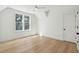 Bright bedroom features hardwood floors, a ceiling fan, and a large window at 806 Jungle Rd, Edisto Island, SC 29438