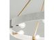 Close-up of modern chandelier with fabric detailing and brass hardware at 806 Jungle Rd, Edisto Island, SC 29438