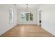 Bright dining room features hardwood floors, large windows, and modern lighting fixture at 806 Jungle Rd, Edisto Island, SC 29438