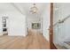 Bright entryway boasts wood floors, white walls, and an elegant light fixture at 806 Jungle Rd, Edisto Island, SC 29438
