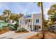 Elegant coastal home with a charming double staircase and a well-manicured, natural landscape at 806 Jungle Rd, Edisto Island, SC 29438