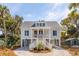 Charming elevated home featuring a welcoming double staircase and classic coastal design elements at 806 Jungle Rd, Edisto Island, SC 29438