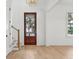 Elegant foyer with light wood floors, white trim, and a view to the outside at 806 Jungle Rd, Edisto Island, SC 29438