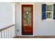 Charming front entrance with a wooden door, blue shutters and light gray siding at 806 Jungle Rd, Edisto Island, SC 29438