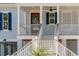 Close-up of the staircase leading to the charming front porch, evoking a warm welcome at 806 Jungle Rd, Edisto Island, SC 29438