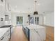 Well-lit kitchen featuring a large island with a sink, and hardwood flooring throughout at 806 Jungle Rd, Edisto Island, SC 29438