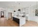 Bright, modern kitchen with a waterfall island, sleek cabinetry, and stainless steel appliances at 806 Jungle Rd, Edisto Island, SC 29438