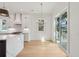 Airy kitchen with large island with quartz countertop, stainless appliances, and outdoor access at 806 Jungle Rd, Edisto Island, SC 29438