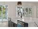 Gourmet kitchen featuring a large island, modern sink, and patio access at 806 Jungle Rd, Edisto Island, SC 29438