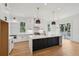 Bright kitchen with large island, modern lighting, and stainless steel appliances at 806 Jungle Rd, Edisto Island, SC 29438