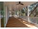 Wide screened-in porch with wood flooring and white railings offering a relaxing outdoor living space at 806 Jungle Rd, Edisto Island, SC 29438
