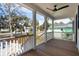 Inviting porch featuring wooden floors, white railings, and a ceiling fan for comfortable outdoor living at 806 Jungle Rd, Edisto Island, SC 29438