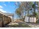 Backyard with fenced perimeter, mature trees, and a storage shed, perfect for outdoor living at 8209 Governors Walk, North Charleston, SC 29418