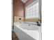 Bathroom with a large tub underneath a window and neutral brown and white tile work at 8209 Governors Walk, North Charleston, SC 29418