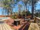 Outdoor deck with fire pit and pergola offering a beautiful view of the pool, ideal for entertaining guests at 8209 Governors Walk, North Charleston, SC 29418