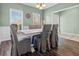 Cozy dining area with a large table, seating for six, and natural light streaming through the windows at 8209 Governors Walk, North Charleston, SC 29418