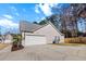 Attached two-car garage featuring a white garage door and concrete driveway providing ample parking space at 8209 Governors Walk, North Charleston, SC 29418