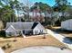 Charming single-story home with a well-manicured lawn, long driveway, and mature trees offering shade and curb appeal at 8209 Governors Walk, North Charleston, SC 29418
