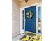Inviting blue front door adorned with a wreath, side windows, and decorative details at 8209 Governors Walk, North Charleston, SC 29418
