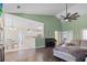 Open-concept living room featuring hardwood floors, vaulted ceilings, and a view into the kitchen at 8209 Governors Walk, North Charleston, SC 29418
