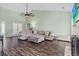 Inviting living room featuring hardwood floors, a large sectional sofa, and a fireplace at 8209 Governors Walk, North Charleston, SC 29418