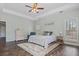 This main bedroom features a ceiling fan, a light color palette and dark wood flooring at 8209 Governors Walk, North Charleston, SC 29418