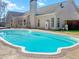 Backyard swimming pool surrounded by a large patio, ideal for outdoor entertainment and relaxation at 8209 Governors Walk, North Charleston, SC 29418