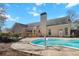 Backyard featuring a sparkling swimming pool with patio and a well-maintained house, perfect for outdoor enjoyment at 8209 Governors Walk, North Charleston, SC 29418