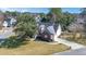 An aerial view of the house, showcasing its roof and the expansive surrounding lawn at 8696 Spring Chapel Ln, North Charleston, SC 29420