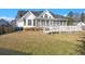 Spacious backyard with a screened porch, deck, and manicured lawn at 8696 Spring Chapel Ln, North Charleston, SC 29420